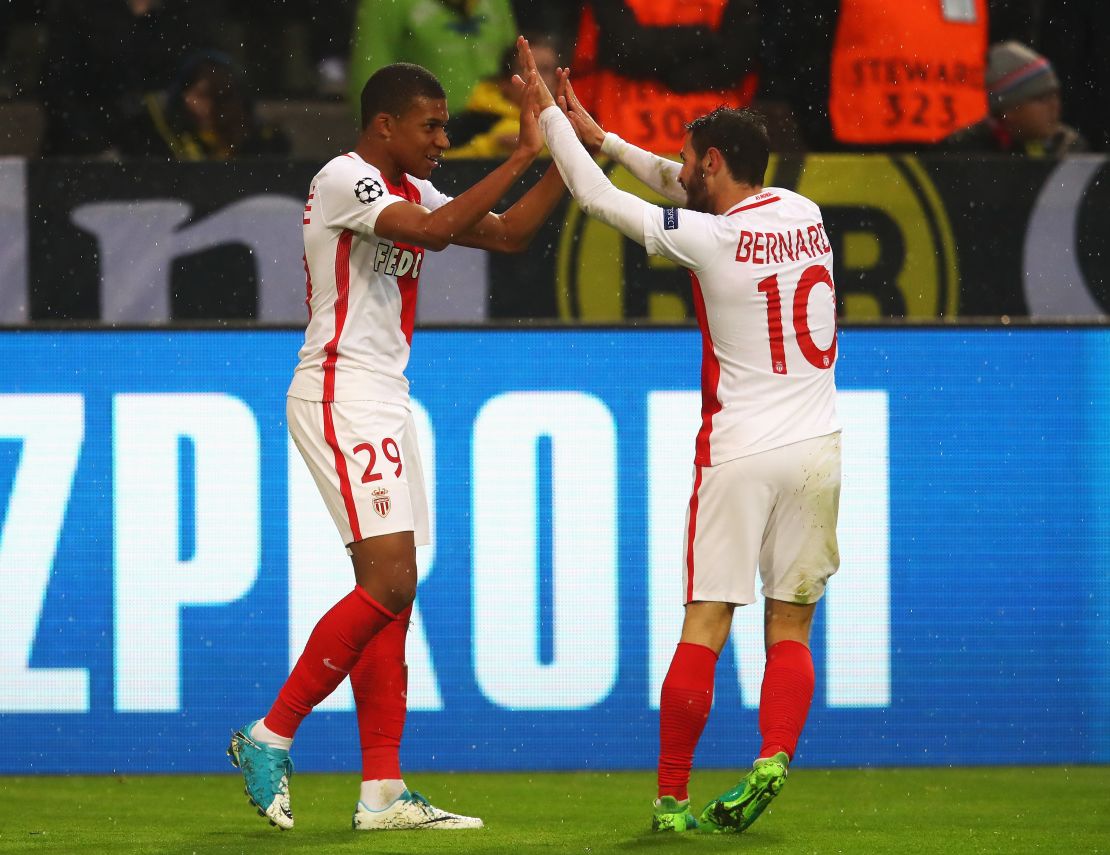 Striker Kylian Mbappe celebrates with Bernardo Silva after scoring the first of his two goals against Dortmund.