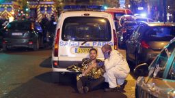 PARIS, FRANCE - NOVEMBER 13:  A medic tends to a man November 13, 2013 in Paris, France. Gunfire and explosions in multiple locations erupted in the French capital with early casualty reports indicating at least 60 dead. (Photo by Thierry Chesnot/Getty Images)