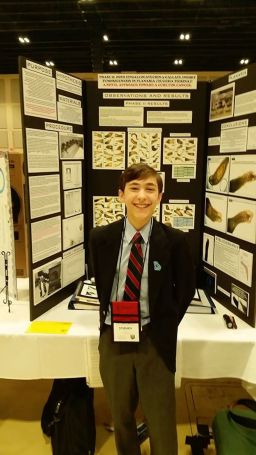 Stephen stands with his Georgia Science and Engineering Fair project in Powder Springs, Georgia.