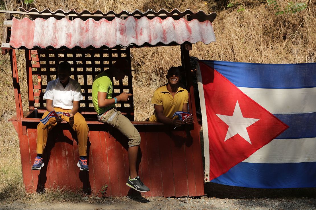 Young men wait by the side of the road for the remains of former Cuban President Fidel Castro to pass by on their four-day journey across the country. 