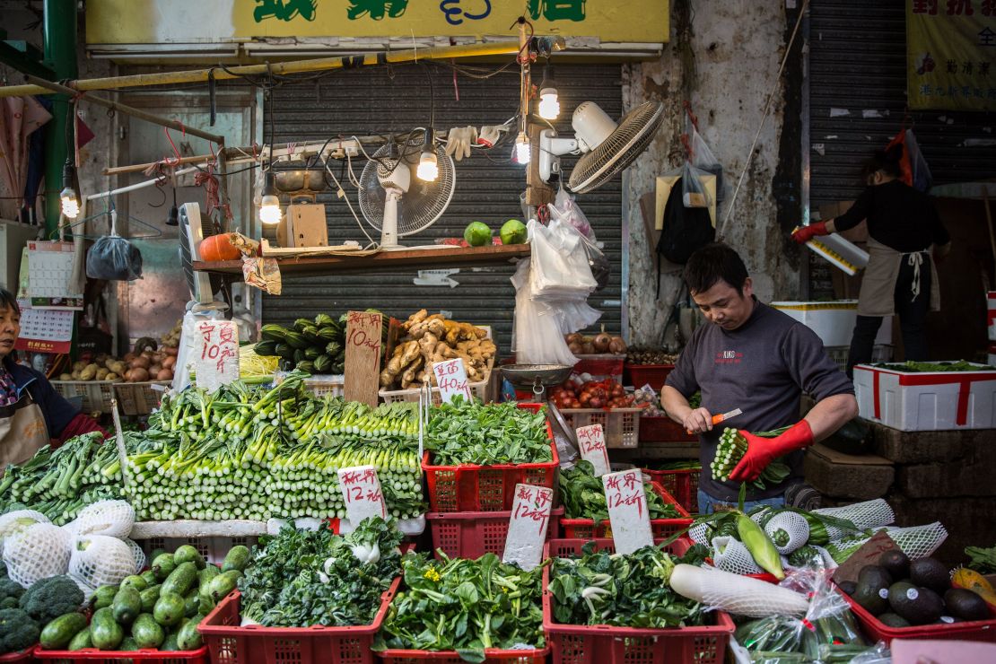 A vegetable vendor on Graham Street, the site of one of the oldest wet markets in Hong Kong.  