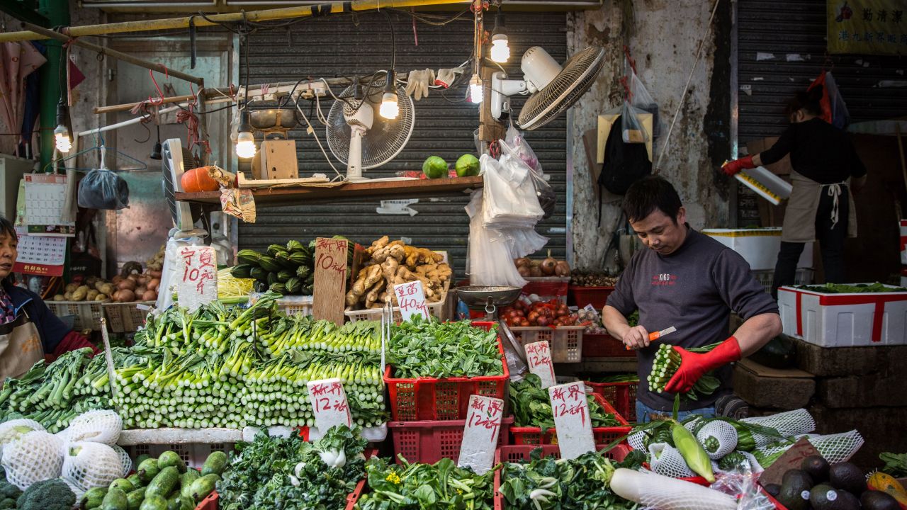 A vegetable vendor on Graham Street, the site of one of the oldest wet markets in Hong Kong.  