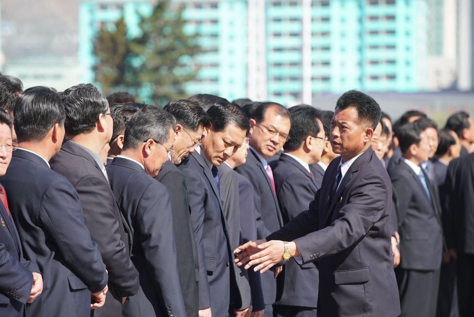 North Koreans gather to witness the opening of the Ryomyong Street housing development.