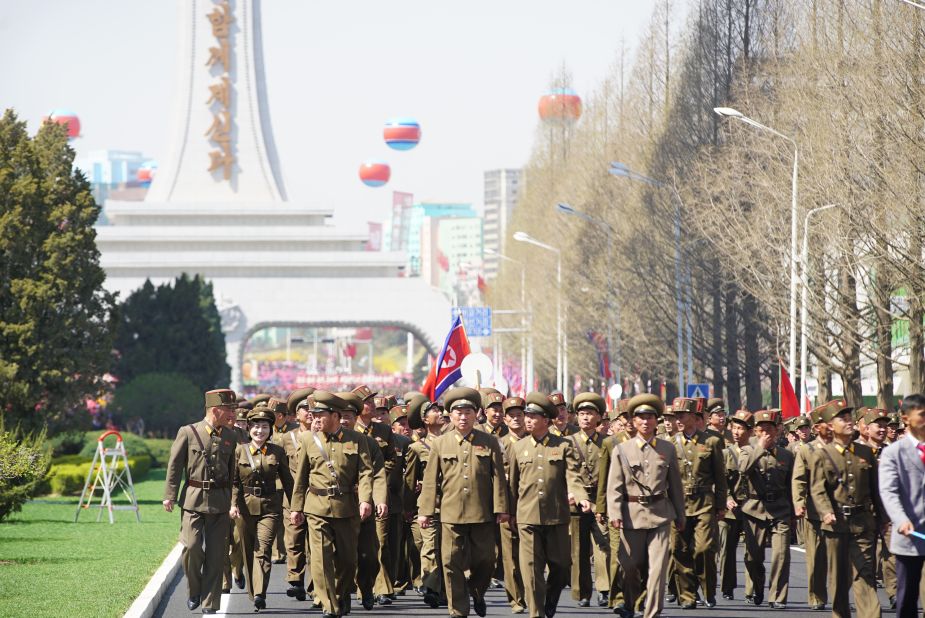 After the opening, the soldiers who built the street walk down it.