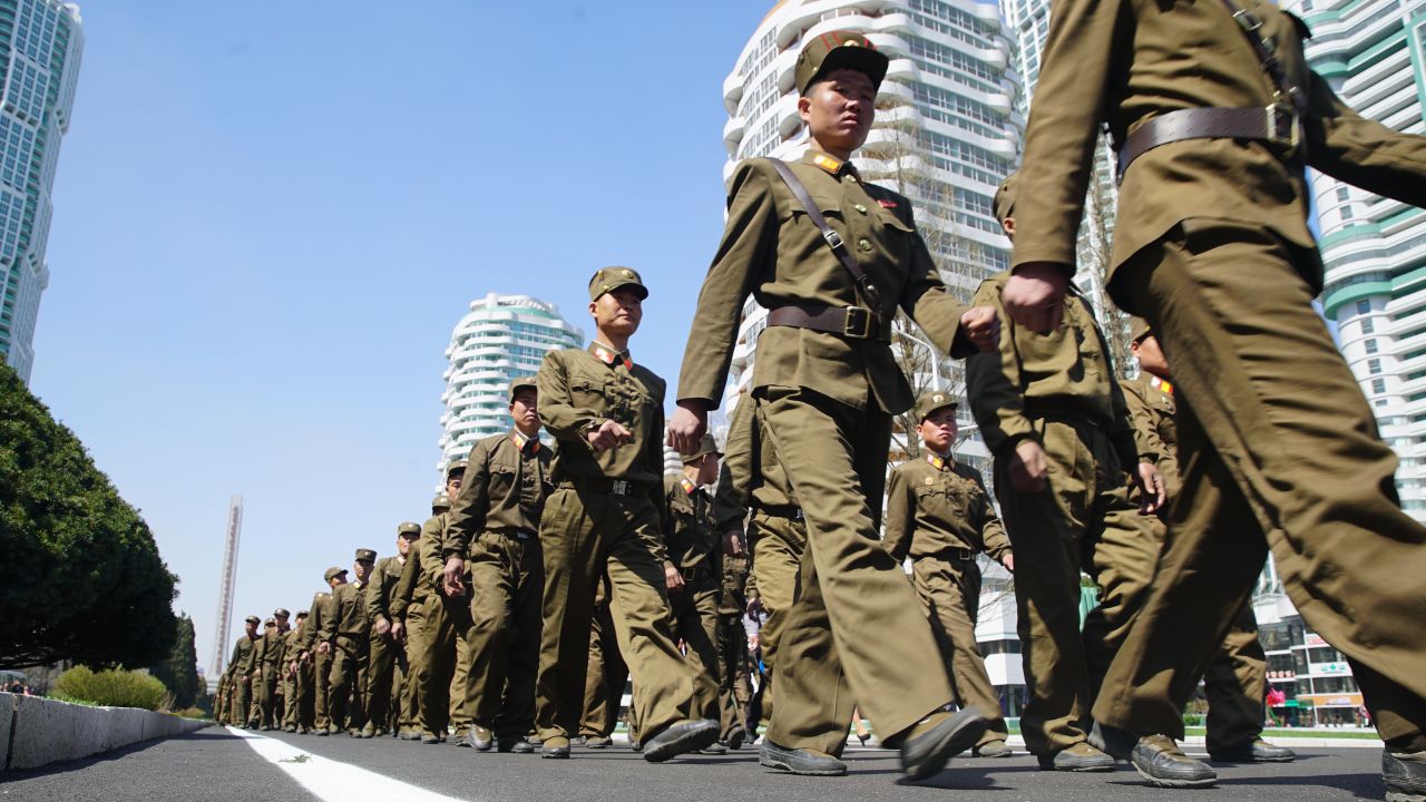 Soldiers march during the opening of Ryomyong Street.