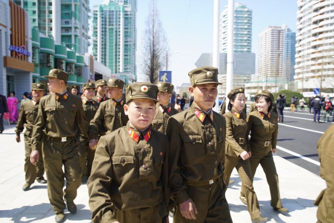 Soldiers leave the opening ceremony of the Ryomyong Street development.