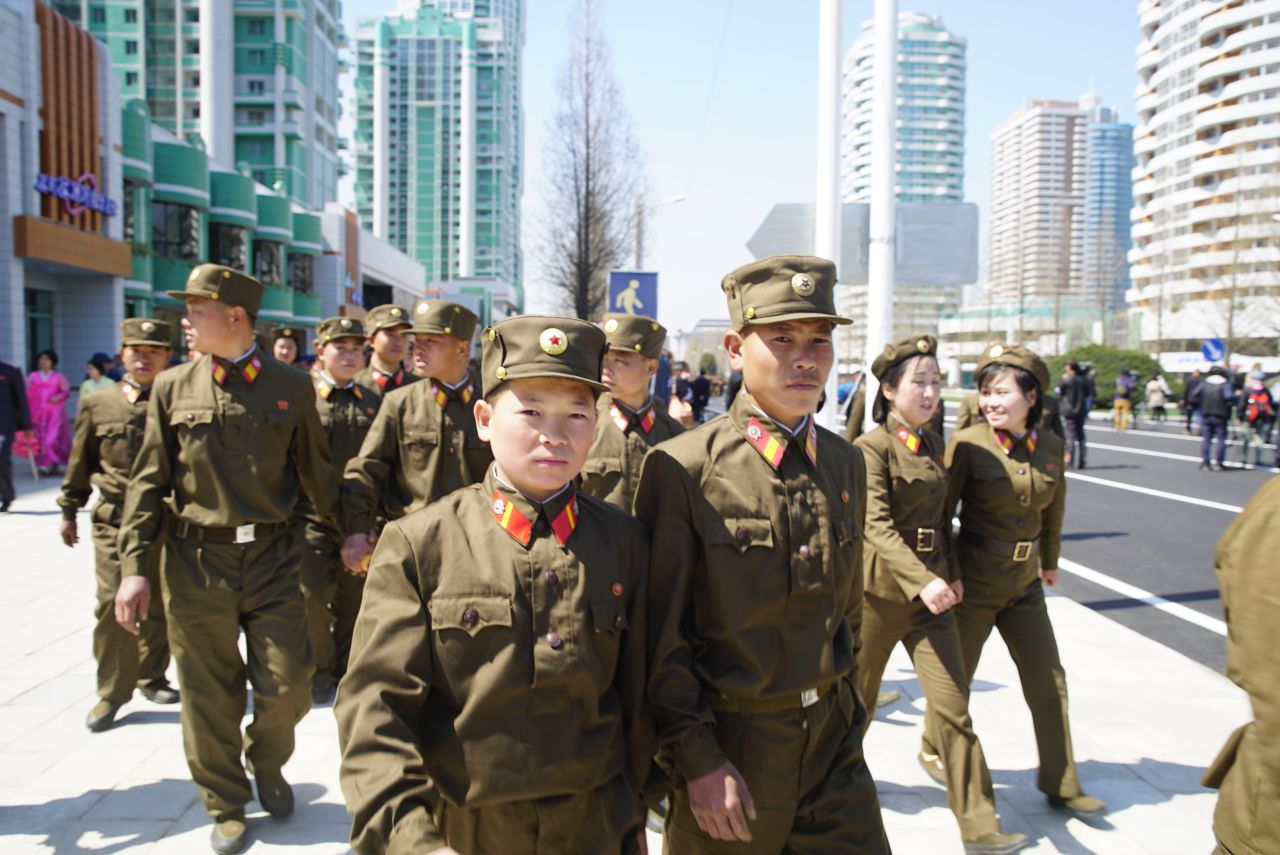 Soldiers leave the opening ceremony of the Ryomyong Street development.