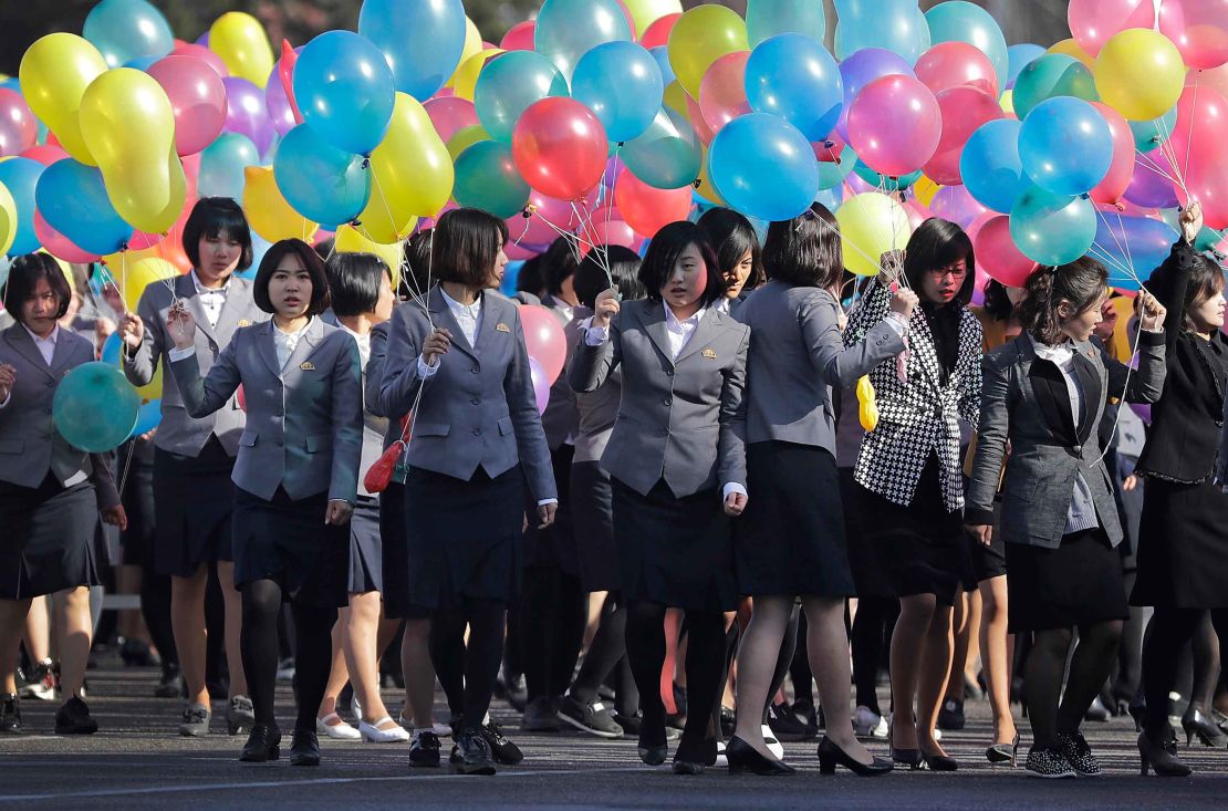 North Korean university students attend the official Ryomyong opening ceremony with balloons.