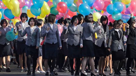 North Korean university students attend the official Ryomyong opening ceremony with balloons.