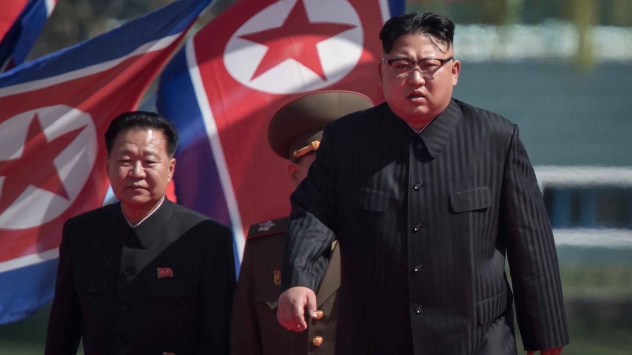 North Korean leader Kim Jong-Un (R) arrives flanked by vice-chairman of the State Affairs Commission Choe Yong-Hae (L) at an opening ceremony for 'Rymoyong street', a new housing development in Pyongyang, on April 13, 2017.
With thousands of adoring North Koreans looking on -- along with invited international media -- Kim Jong-Un opened a prestige housing project as he seeks to burnish his nation's image even as concerns over its nuclear capabilities soar. / AFP PHOTO / ED JONES        (Photo credit should read ED JONES/AFP/Getty Images)