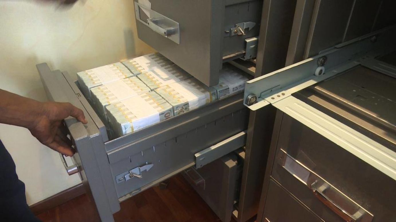 The money was 'neatly arranged' inside cabinets hidden behind wooden panels of a bedroom wardrobe.