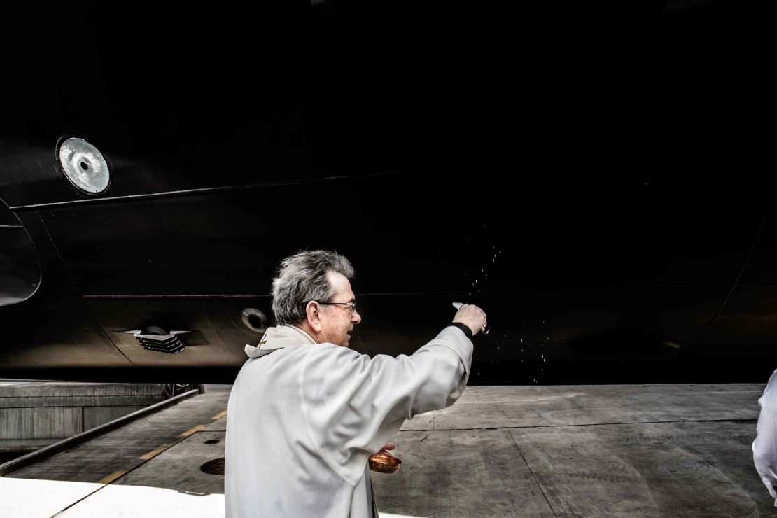 A local priest prepares to bless the new vessel. 