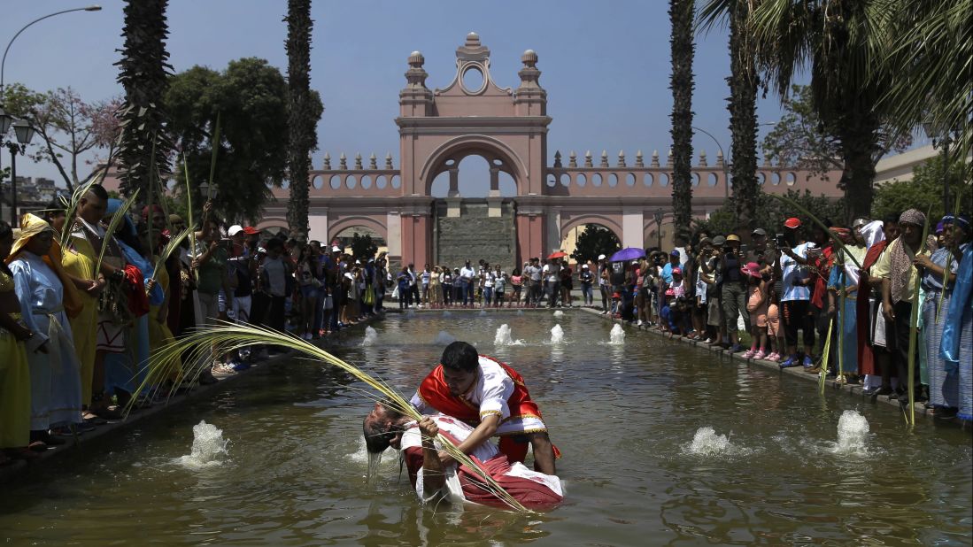 People re-enact the baptism of Jesus during Holy Week celebrations in Lima, Peru, on April 13.