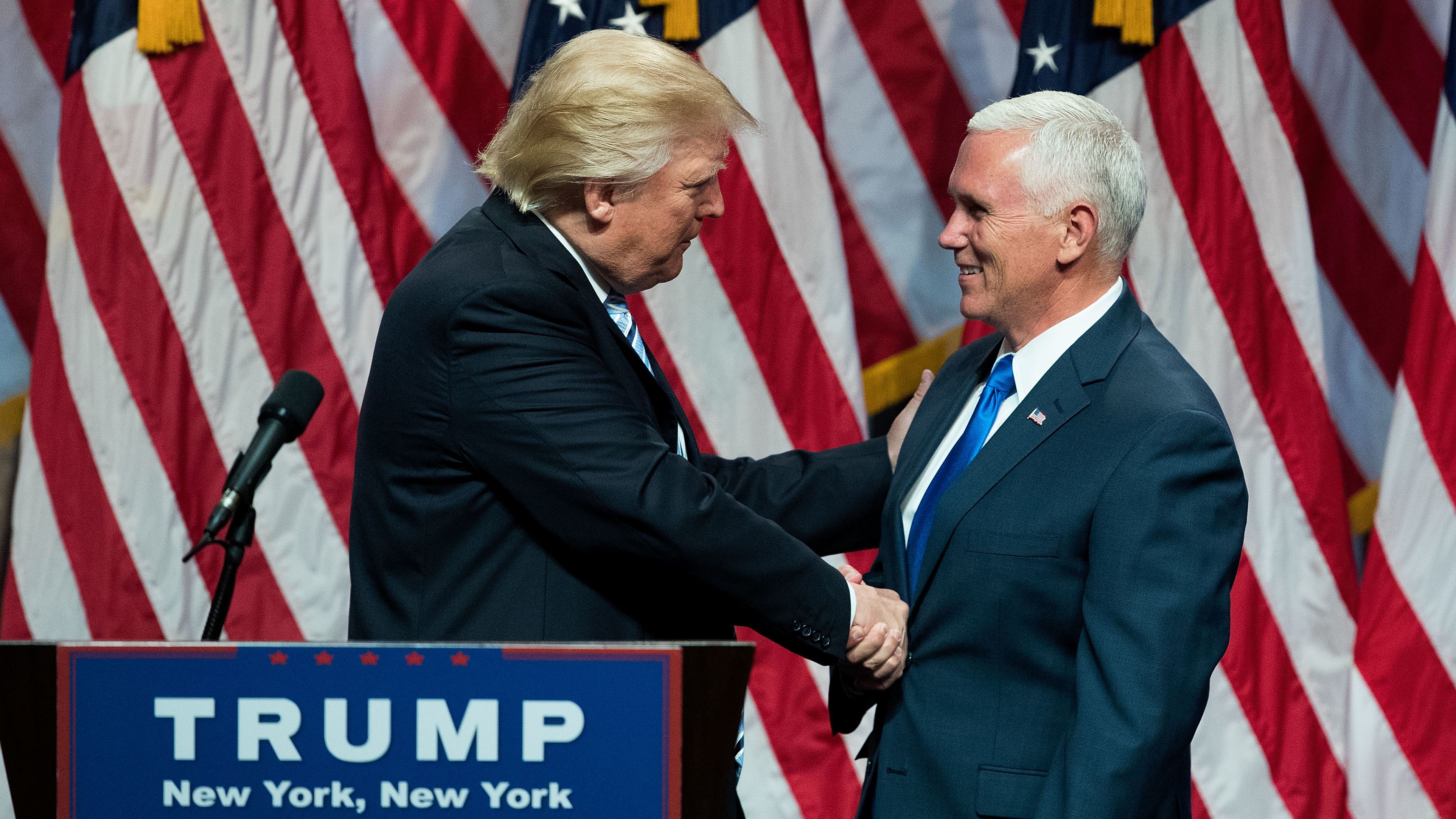 Pence shakes hands with Trump after being selected as his running mate in July 2016.