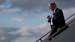 US President Donald Trump pumps his fist to the crowd of supporters as he steps off Air Force One in West Palm Beach, Florida, April 13, 2017. / AFP PHOTO / JIM WATSON        (Photo credit should read JIM WATSON/AFP/Getty Images)