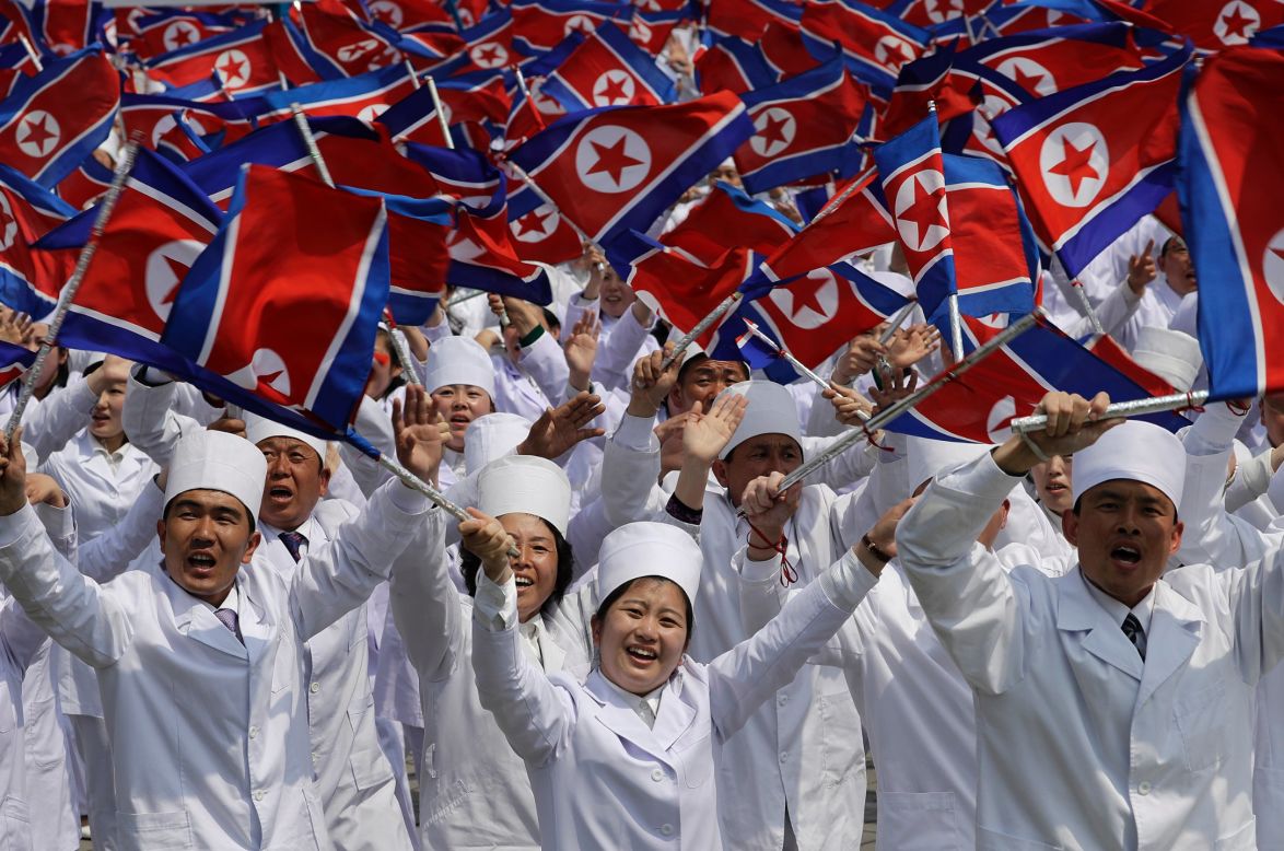 North Korean men and women dressed to represent doctors and other medical workers during the parade. 
