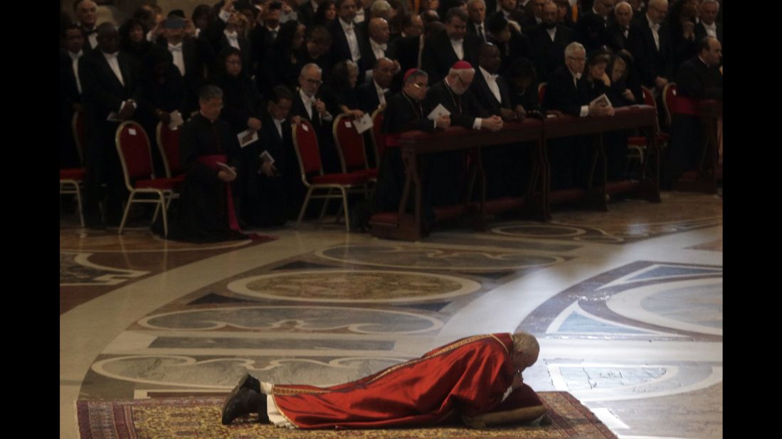 Pope Francis lies down in prayer during the Good Friday Passion of Christ Mass inside St. Peter's Basilica at the Vatican. 
