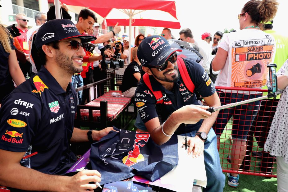 Red Bull Racing's Daniel Ricciardo poses with a fan in Bahrain. 