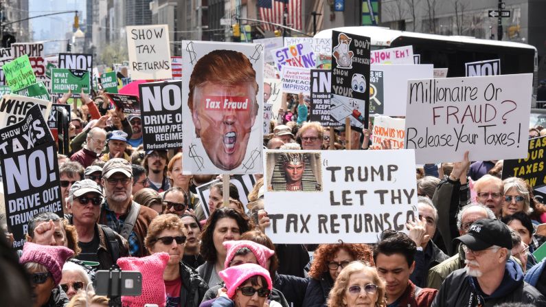 People participate in a Tax Day protest in New York. Trump has said that Americans "don't care at all" about his tax returns, but polls show 74% of Americans say he should release them.