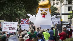 Demonstrators march through downtown Houston demanding greater governmental transparency and the release of President Donald Trump's tax returns during a protest Saturday, April 15, 2017. (Brett Coomer/Houston Chronicle via AP)