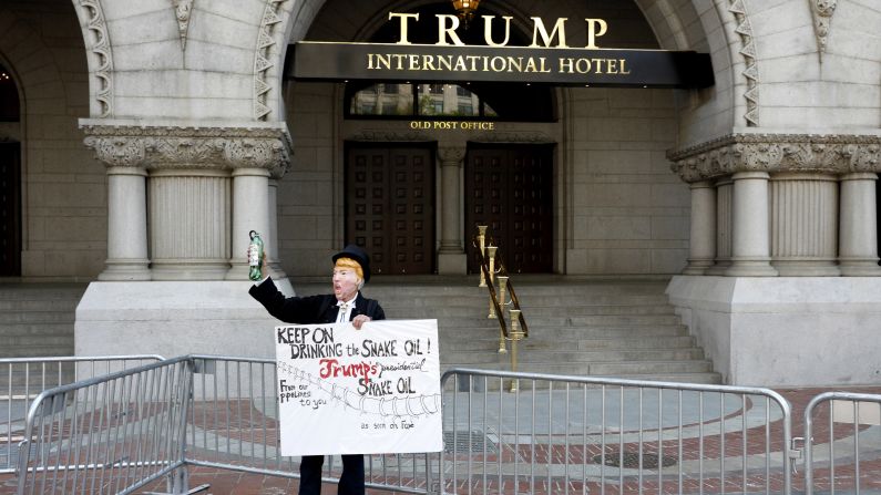 A protester dressed as President Donald Trump stands outside the Trump International Hotel in Washington.