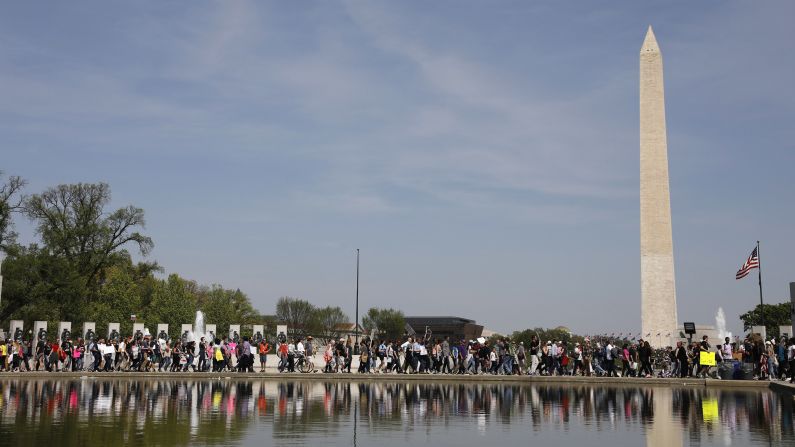 Tax Day demonstrators march to the Lincoln Memorial in Washington.
