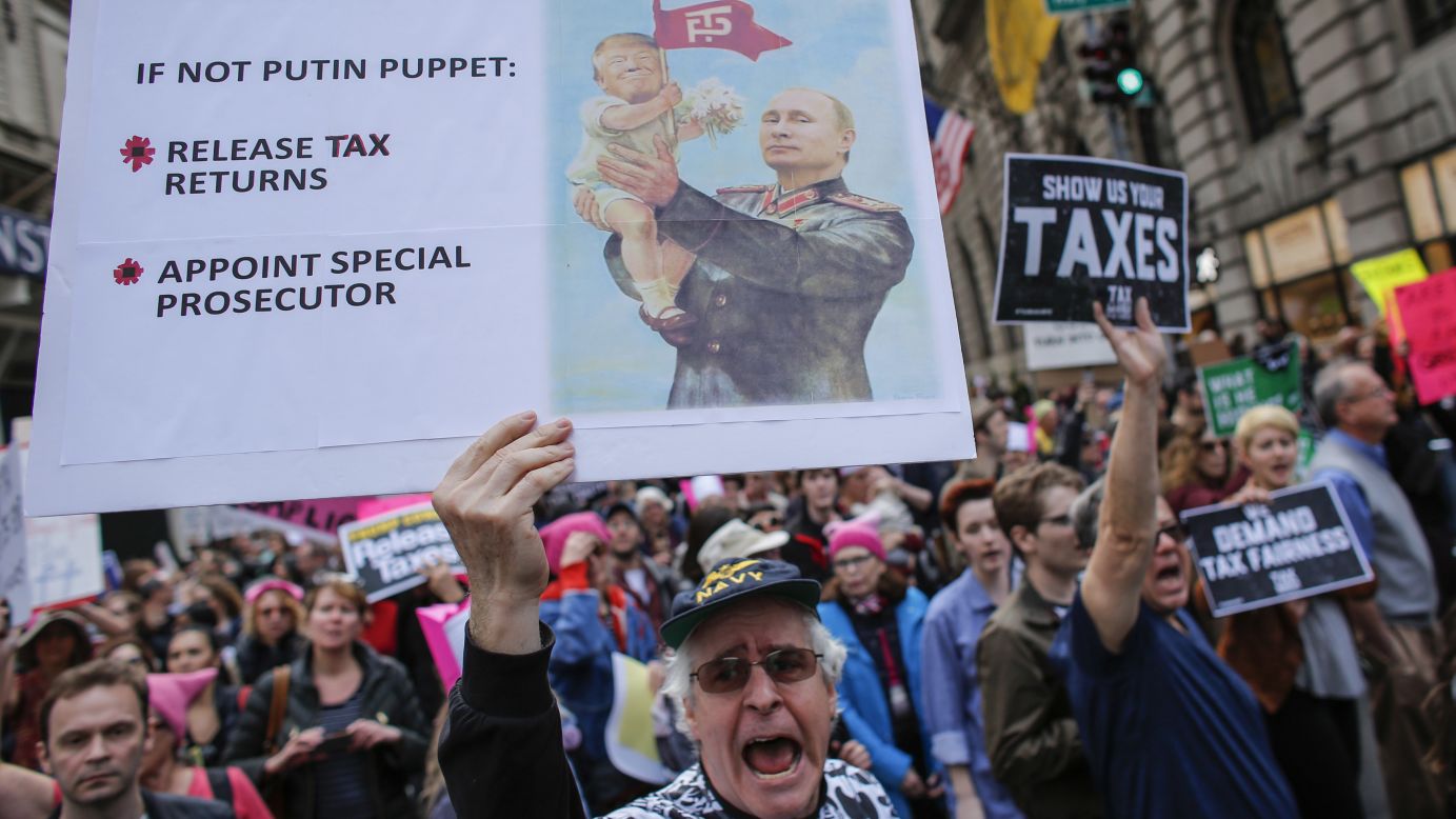 Protesters pass near Trump Tower in New York during the nationwide "Tax March." 