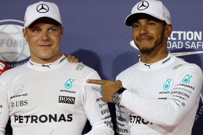 Lewis Hamilton points to Mercedes teammate Valtteri Bottas after the Finn secured the first pole of his career at the Bahrain Grand Prix following Saturday's qualifying session. 