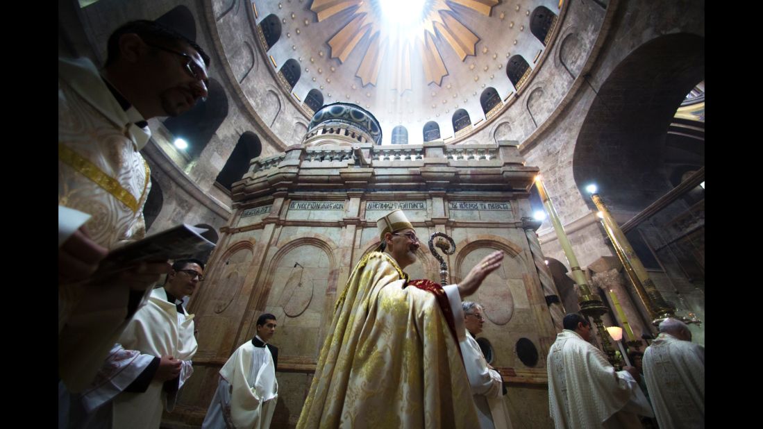 The Latin Patriarch of Jerusalem, Pierbattista Pizzaballa, walks with Christian clergymen holding candles during an Easter Sunday procession at the Church of the Holy Sepulchre in Jerusalem.  