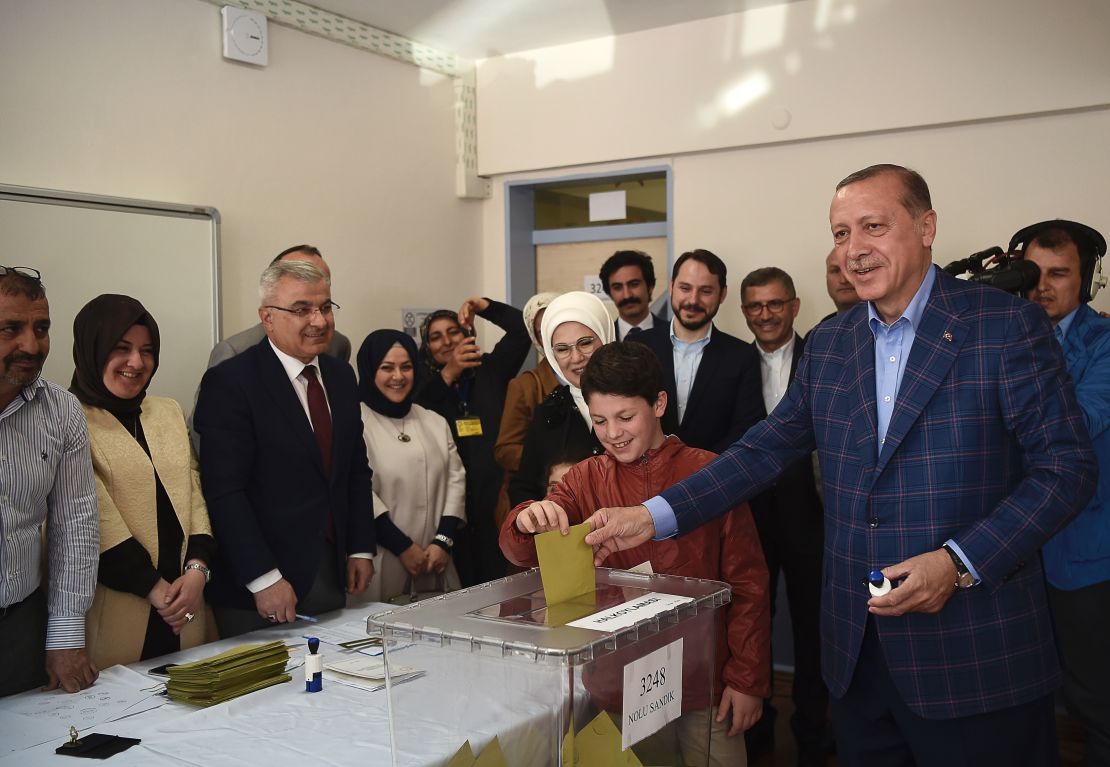 Turkish President Recep Tayyip Erdogan casts his vote accompanied by his wife and grandchildren.
