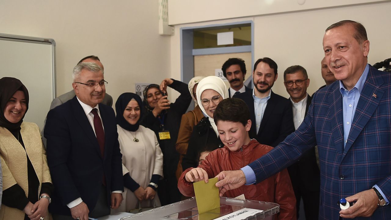 Turkish President Recep Tayyip Erdogan casts his vote accompanied by his wife and grandchildren.