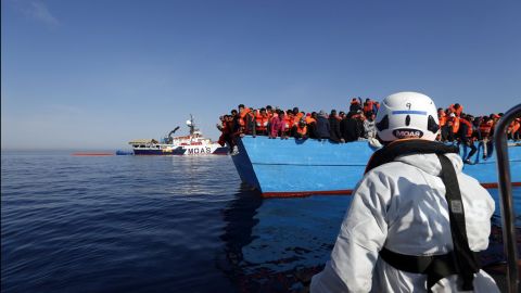 Ships from the humanitarian organization Migrant Offshore Aid Station approach a boat migrants in the middle of the Mediterranean Sea on April 15.