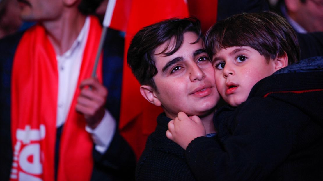 Turkish youths celebrate in Ankara moments after preliminary results showed a "Yes" win. 