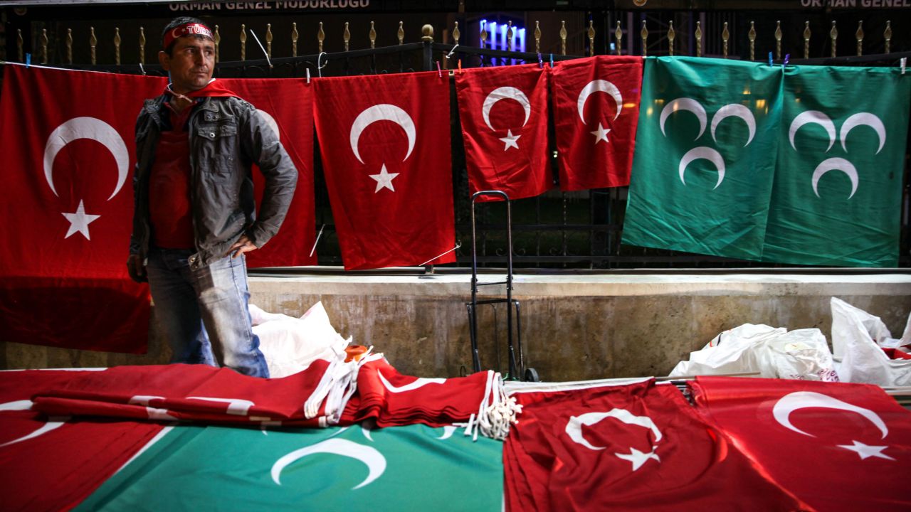 A vendor sells Turkish flag themed items on the night of the referendum result in Ankara.