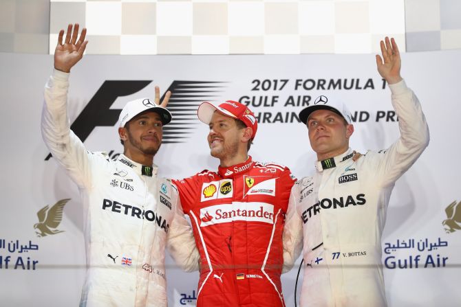 Vettel on the podium with second-placed Lewis Hamilton (left) and Valtteri Bottas who came home third.