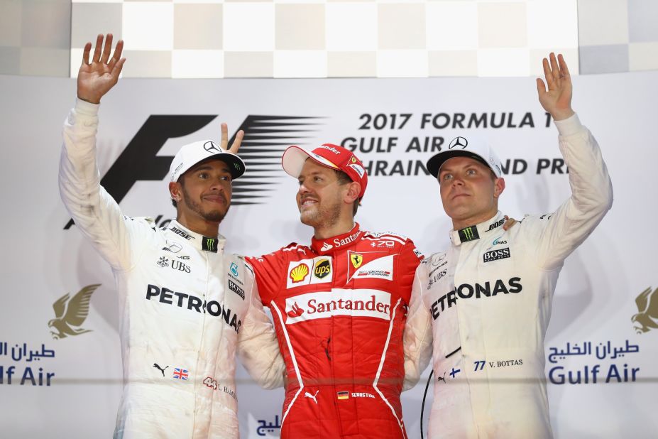 Vettel on the podium with second-placed Lewis Hamilton (left) and Valtteri Bottas who came home third. 