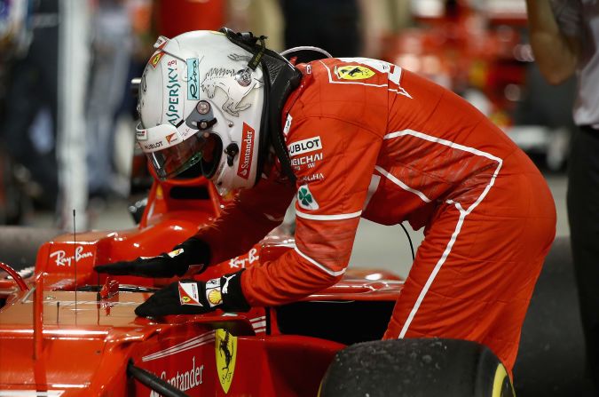 Vettel pats his car -- which he has christened "Gina" -- in parc ferme after winning in Bahrain.