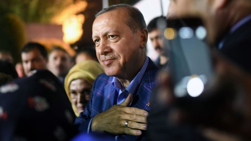 Turkish president Recep Tayyip Erdogan (C), flanked by his wife Emine Erdogan (rear L), acknowledges supporters, during a rally, as he leaves after delivering a speech at the conservative Justice and Development Party (AKP) headquarters in Istanbul, on April 16, 2017, following the results of a nationwide referendum that will determine Turkey's future destiny.
Erdogan on April 16, 2017 hailed Turkey for making a "historic decision" as he claimed victory in the referendum on a new constitution expanding his powers. The "Yes" campaign to give Turkish President expanded powers won with 51.3 percent of the vote a tightly-contested referendum although the "No" camp had closed the gap, according to initial results. But Turkey's two main opposition parties said they would challenge the results. / AFP PHOTO / Bulent Kilic        (Photo credit should read BULENT KILIC/AFP/Getty Images)
