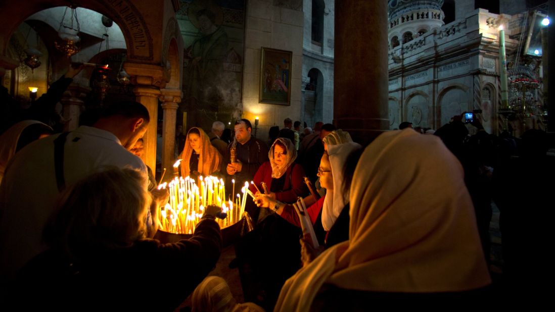 Christian pilgrims in Jerusalem light candles April 16 during the Easter Sunday procession at the Church of the Holy Sepulchre, traditionally believed by many Christians to be the site of the crucifixion and burial of Jesus. 