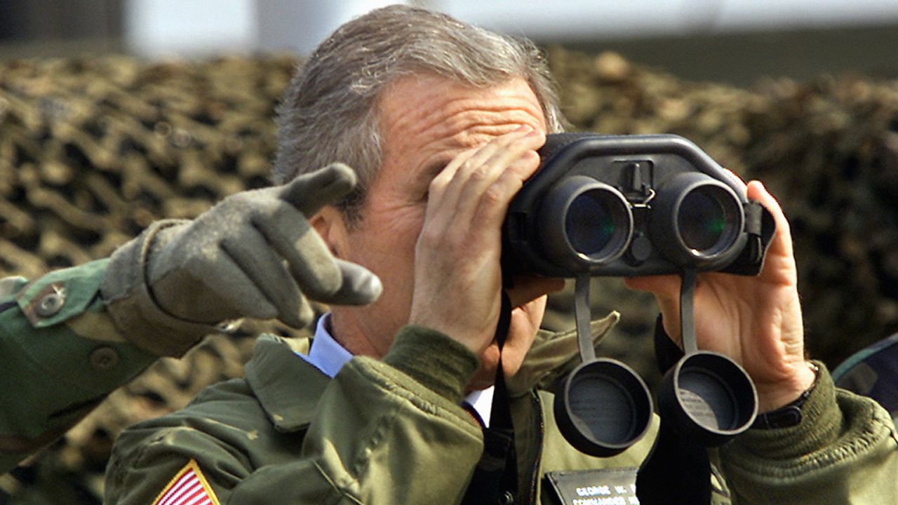 US President George W. Bush looks at North Korea from Observation Point Ouellette in the DMZ on Feb. 20, 2002. The president visited the zone to express his hope for communist North Korea to rejoin democratic South Korea someday.