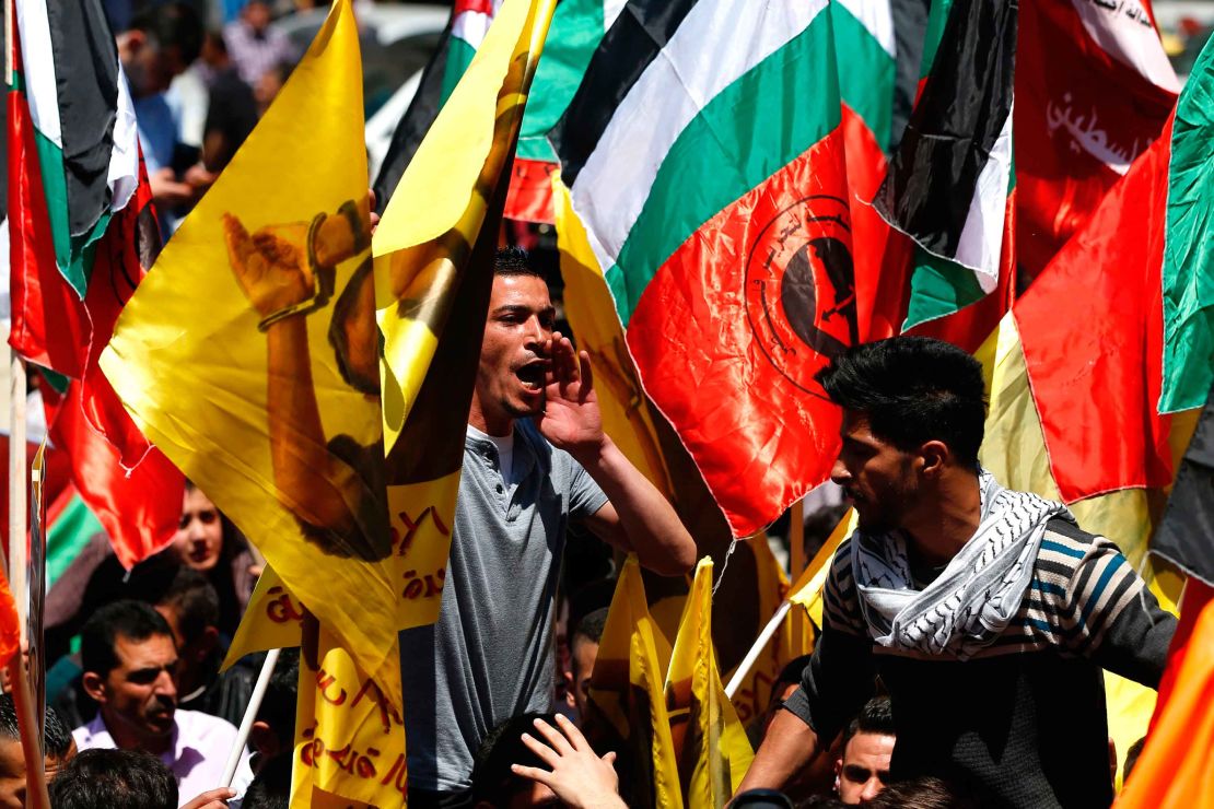 Protesters show their support for jailed Palestinians in a rally in Ramallah Monday. 