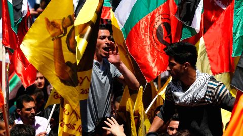 Protesters show their support for jailed Palestinians in a rally in Ramallah Monday.