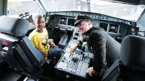 Nathaniel Underwood, 5, sits in the cockpit of a Delta Airbus A320 with Captain Erich Ries.