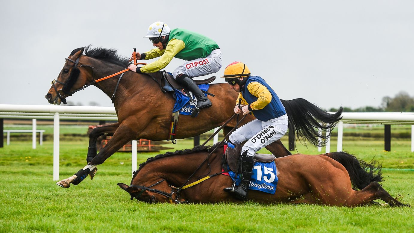 Jockeys Davy Russell and Sean Flanagan race in the Fairyhouse Easter Festival in Meath, Ireland, on Sunday, April 16. Flanagan and his horse, Runforbob, fell during this maiden hurdle.