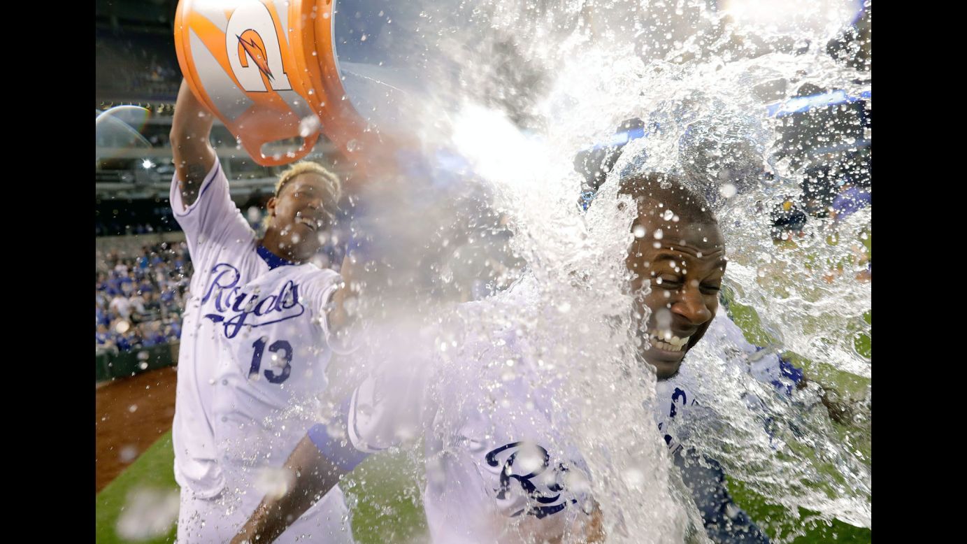 Salvador Perez of Kansas City dumps a bucket of water over teammate and MVP Lorenzo Cain after their team defeated Oakland 3-1 in Kansas City on Thursday, April 13.