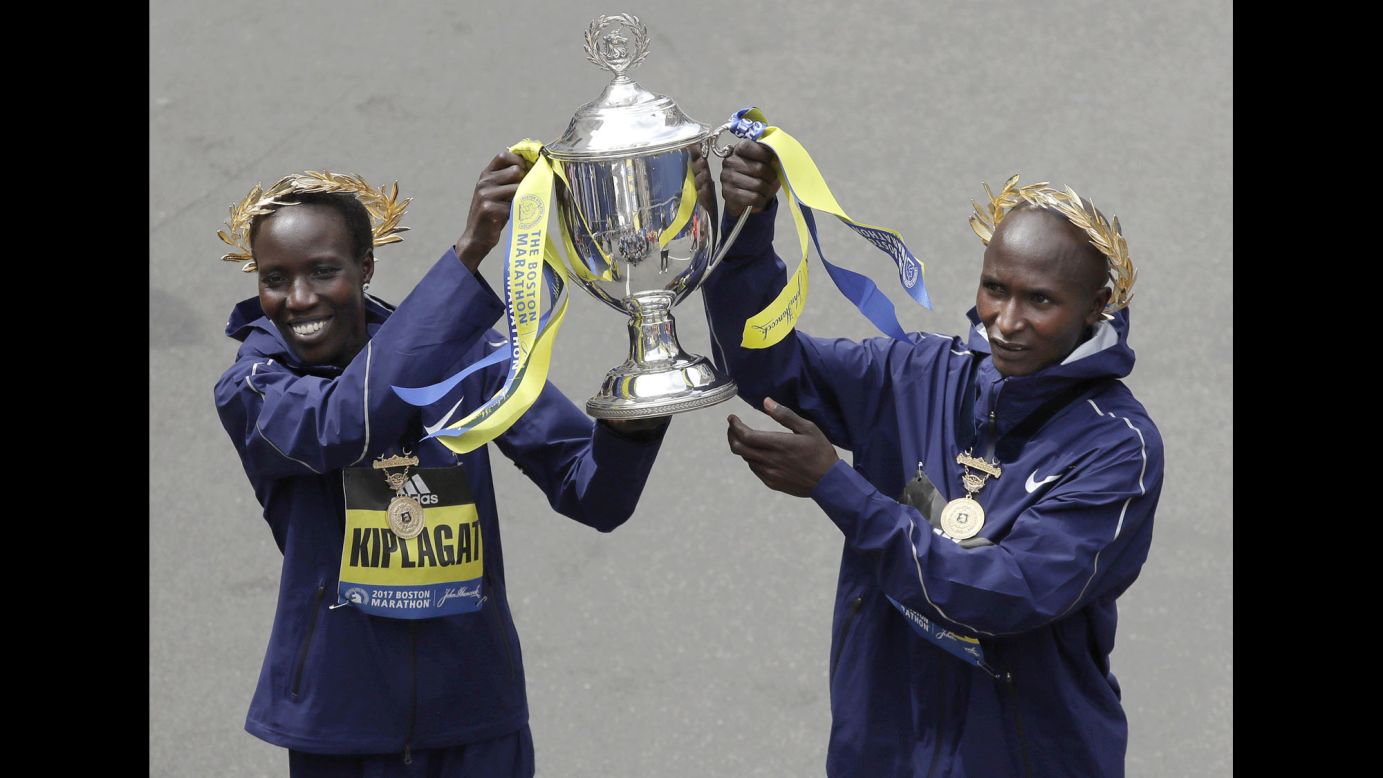 Kenya's Edna Kiplagat, left, and Geoffrey Kirui hold a trophy after their victories in the Boston Marathon on Monday, April 17. Kiplagat finished in 2:21:52 and Kirui finished in 2:09:37, winning the women's and men's races, respectively.