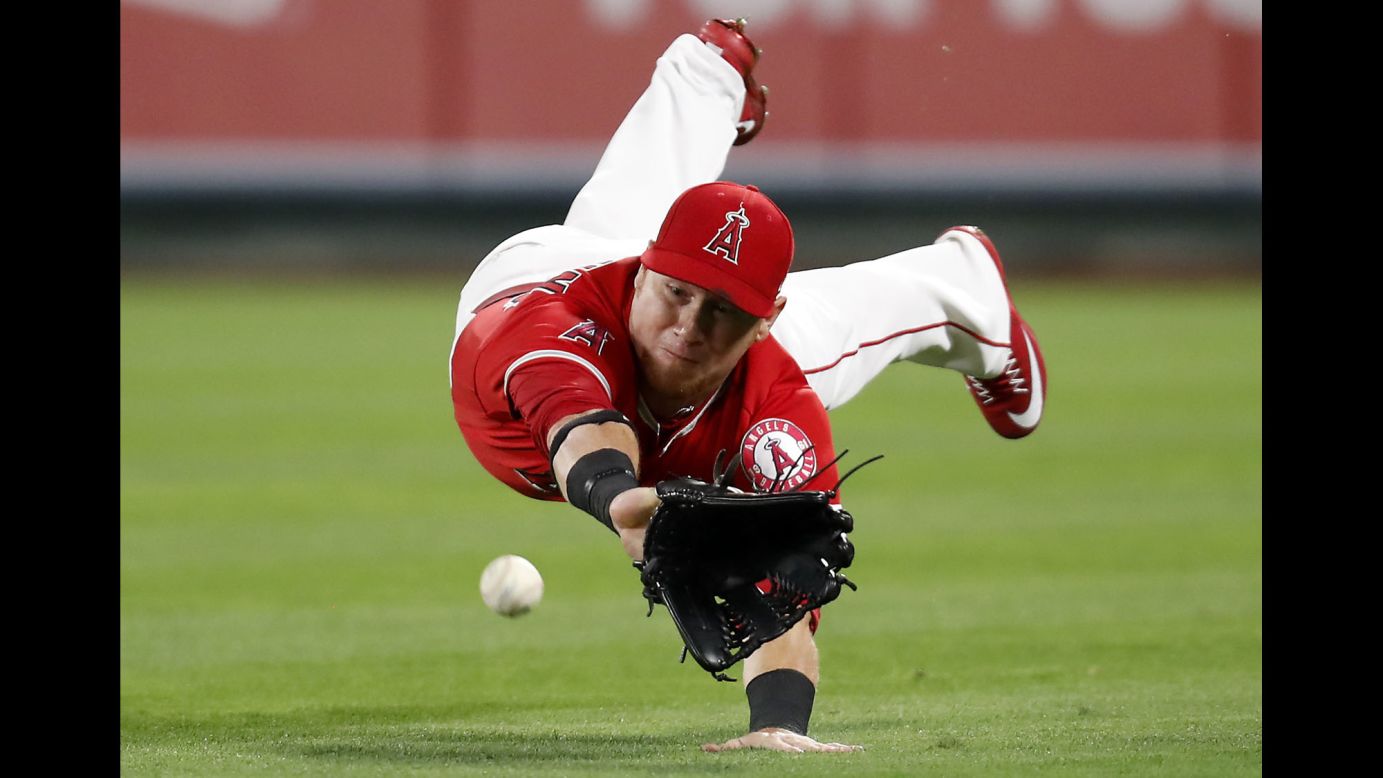 Los Angeles right fielder Kole Calhoun dives but misses a single by Texas' Jonathan Lucroy during a game in Anaheim, California, on Wednesday, April 12. Texas won 8-3.