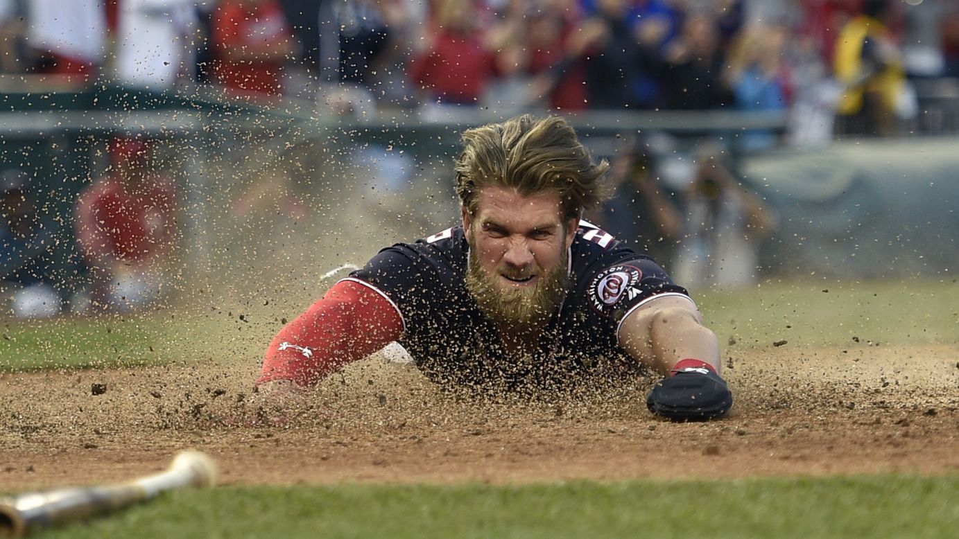 Washington's Bryce Harper slides home to score the winning run on a hit by Daniel Murphy during a game against Philadelphia on Friday, April 14. Washington won 3-2.
