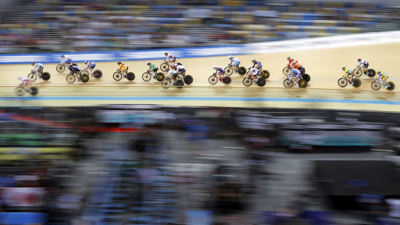 This panning shot shows track cyclists as they compete in the women's scratch race at the Track Cycling World Championships in Hong Kong on Wednesday, April 12.