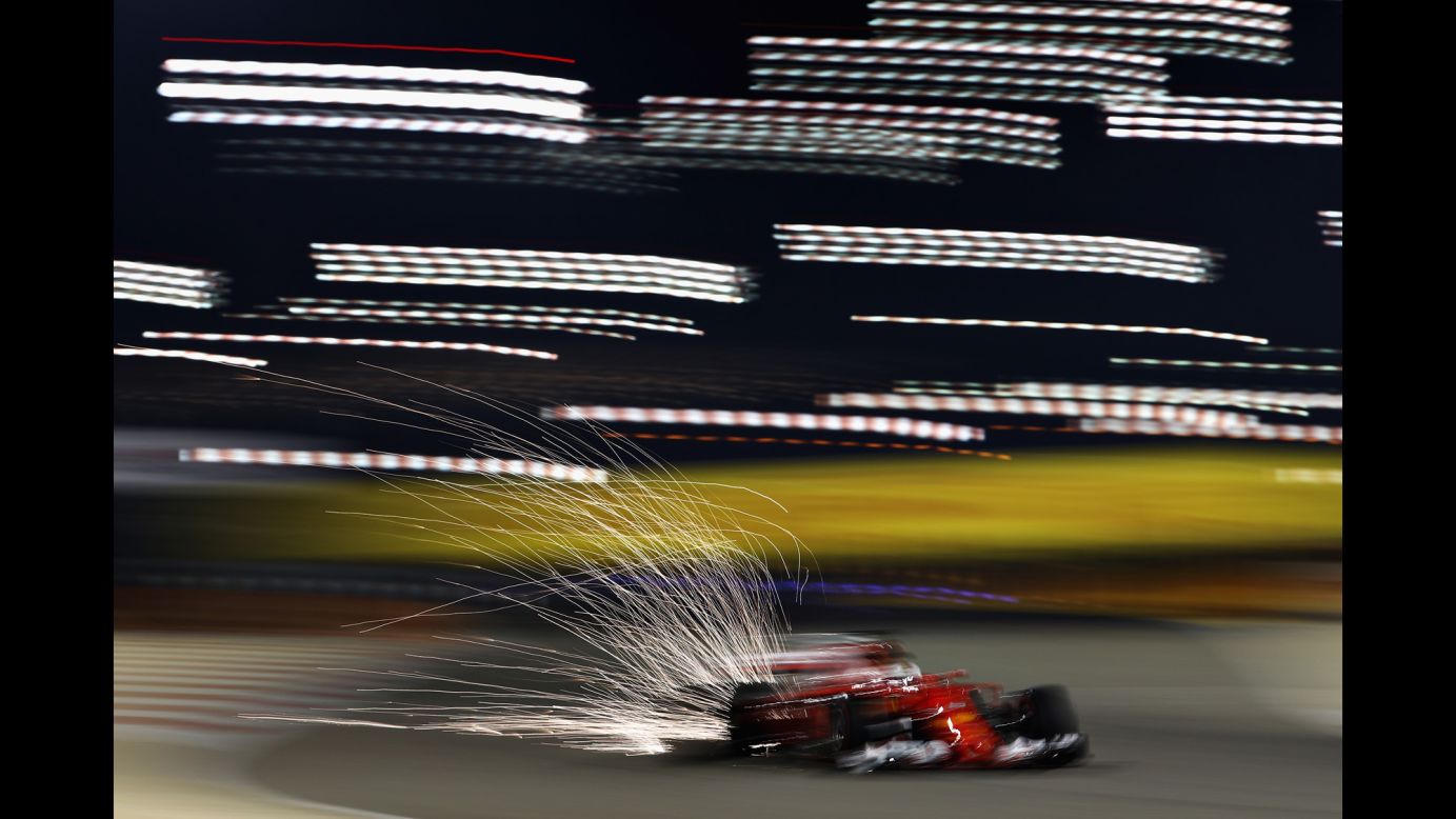 This panning shot captures sparks flying behind Germany's Sebastian Vettel during a track practice for the Bahrain Formula One Grand Prix on Friday, April 14.